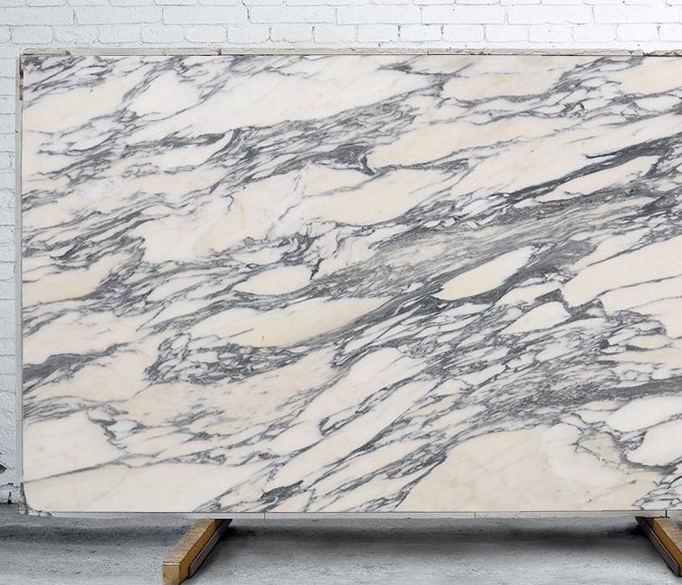 Close up of Arabescato Marble with intricate grey veining on a white background
