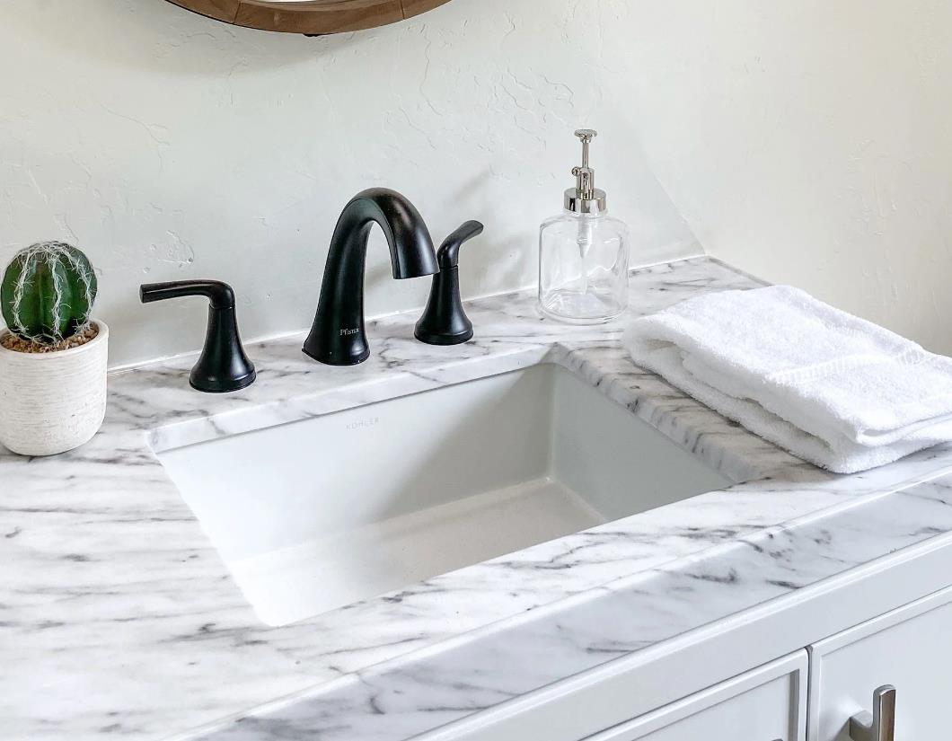 Modern white bathroom countertop with sink and faucet