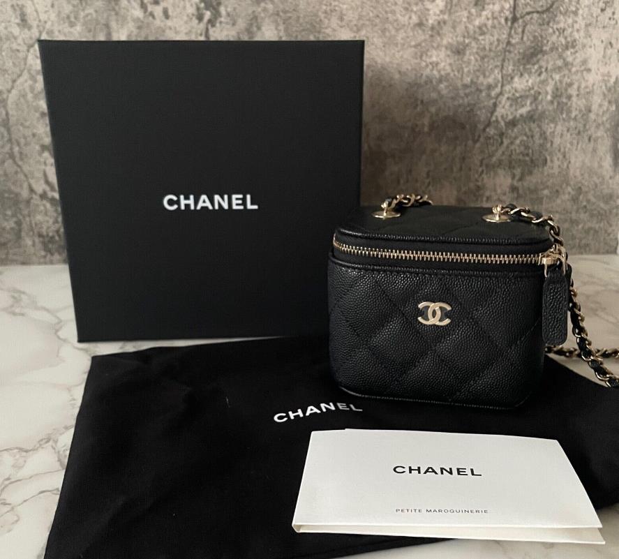 Black Chanel Vanity Bag with gold chain strap and logo on front flap