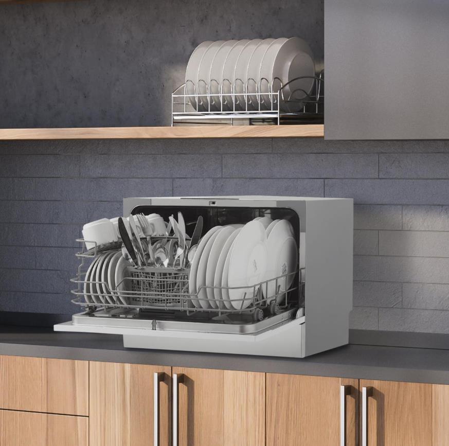 A compact countertop dishwasher in a modern kitchen setting