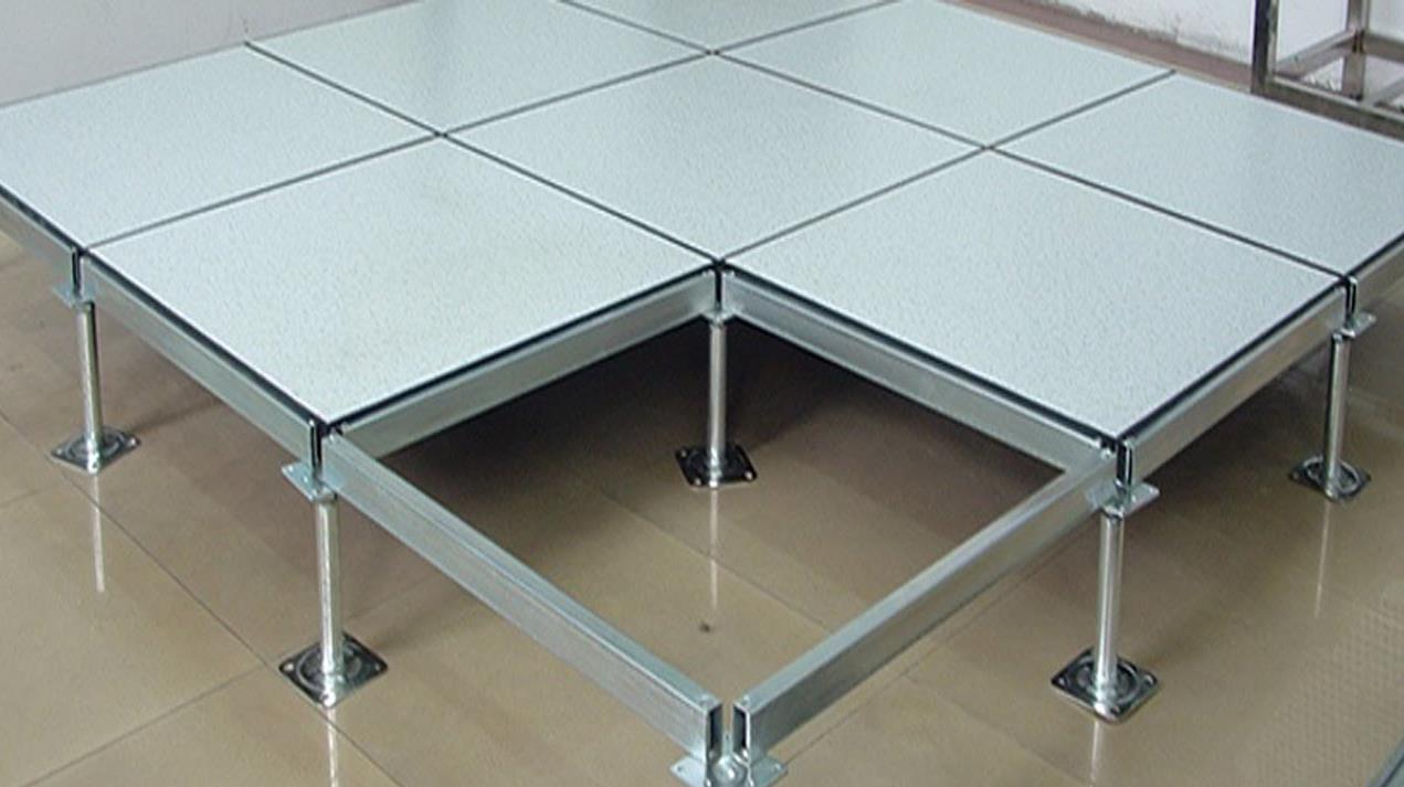 Close-up view of raised floor panels and support structure in an office building