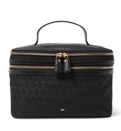 A stylish black vanity bag with gold hardware and a shoulder strap