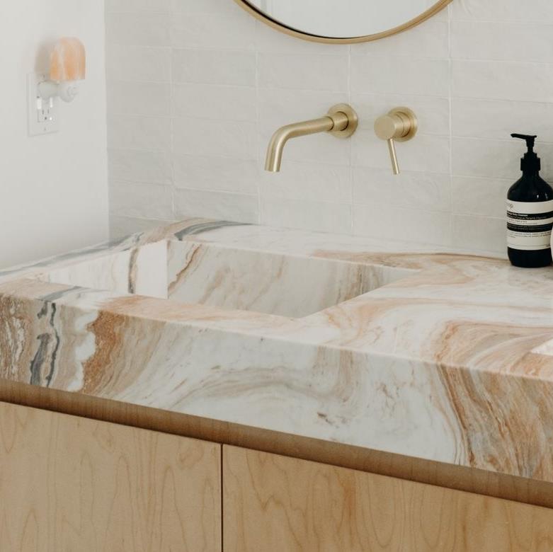Modern vanity bathroom with double sinks, marble countertops, and sleek fixtures