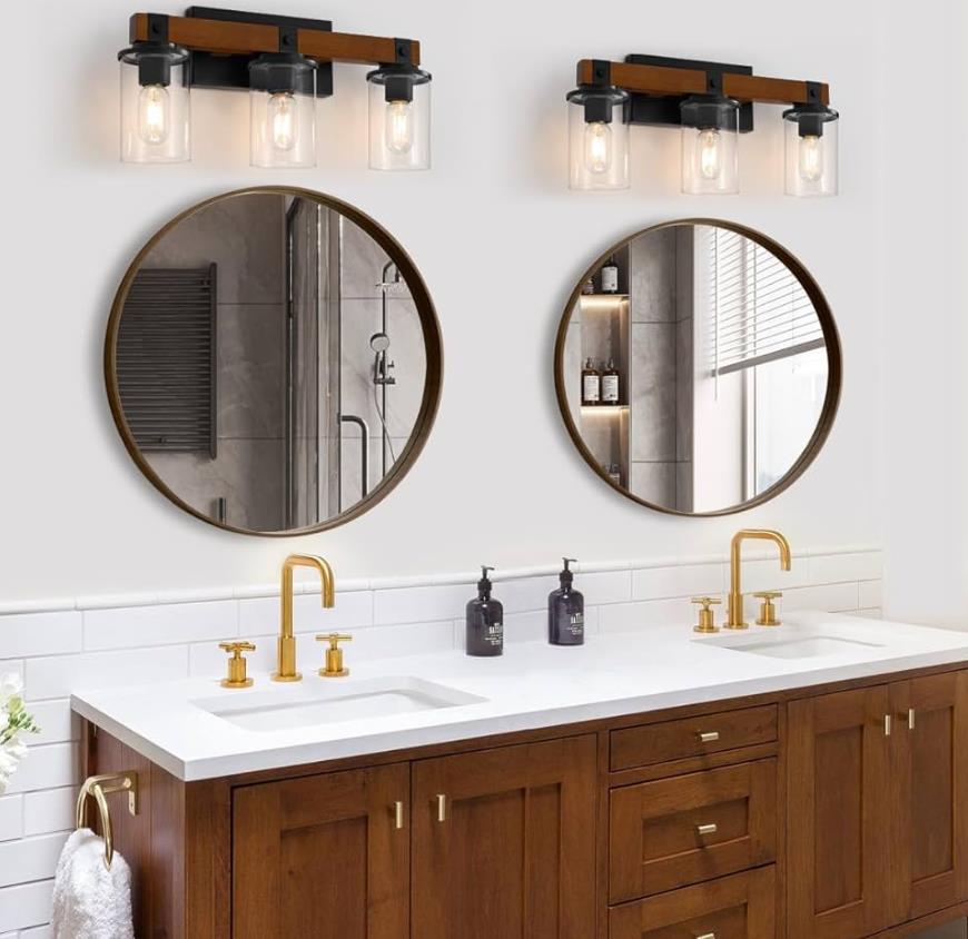 A row of modern vanity lights illuminating a bathroom mirror.