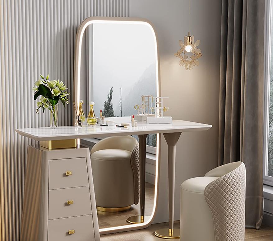 A white vanity table with a mirror, drawers, and a stool