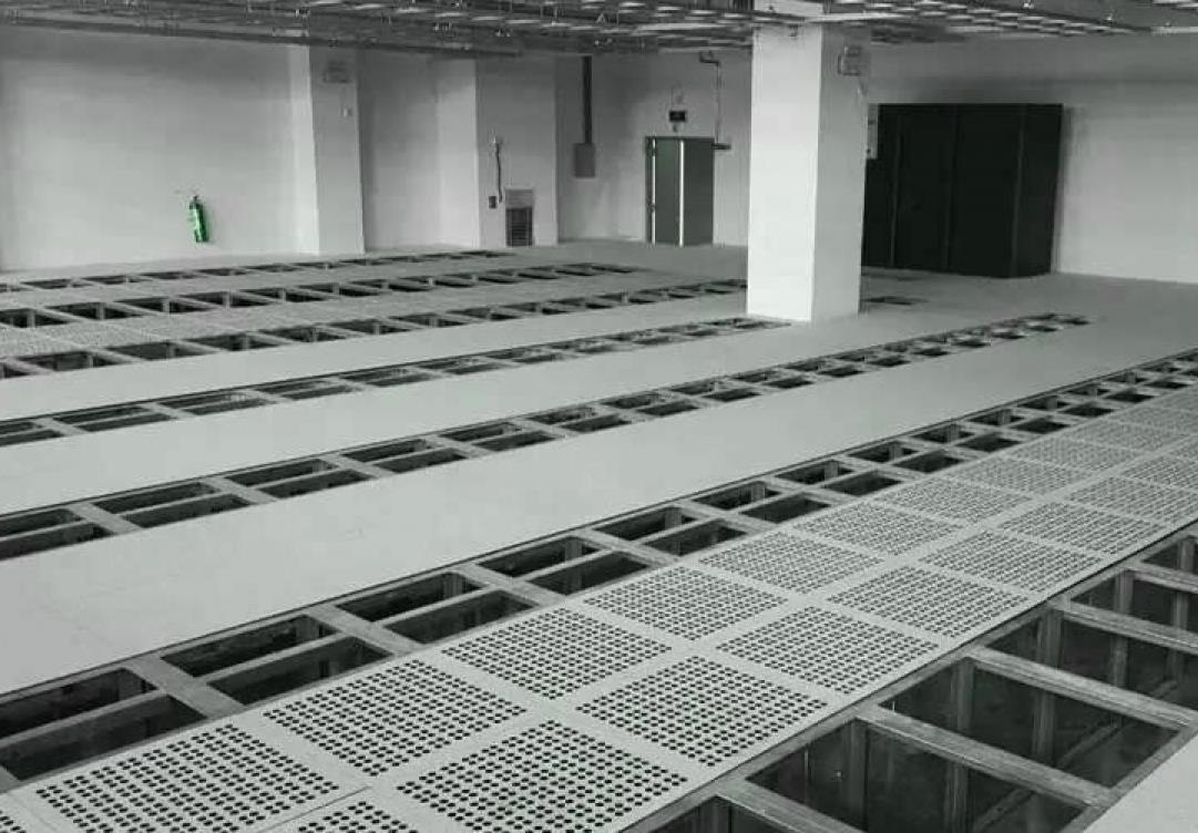 A raised floor with metal grates and cables running underneath.