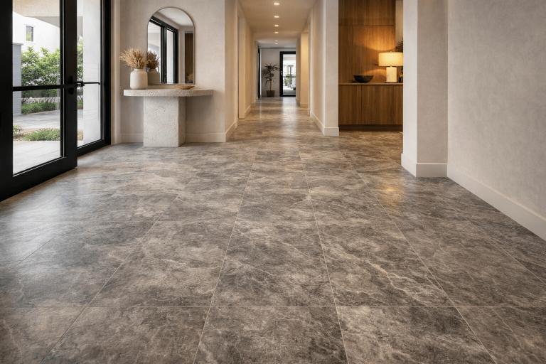 Entry foyer finished with Ocean Grey marble, featuring subtle veining and a sleek, welcoming first impression.